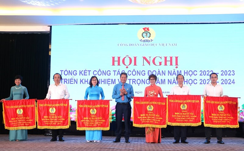 Ông Huỳnh Thanh Xuân - Phó Chủ tịch Tổng Liên đoàn Lao động Việt Nam - trao Cờ thi đua của Tổng LĐLĐVN cho các đơn vị xuất sắc thuộc Công đoàn Giáo dục Việt Nam. Ảnh: Đình Tuệ