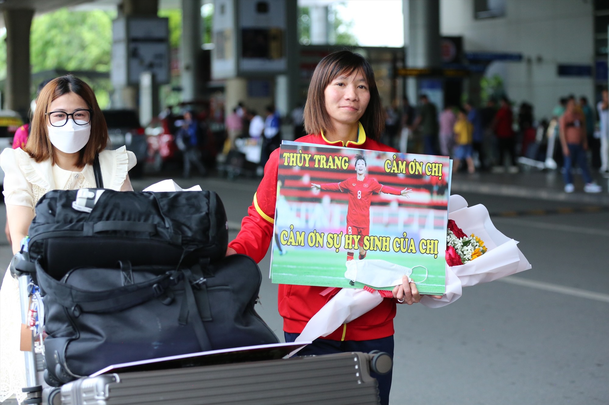 Thuỳ Trang nhận hoa từ người hâm mộ tại sân bay Tân Sơn Nhất. Ảnh: Thanh Vũ
