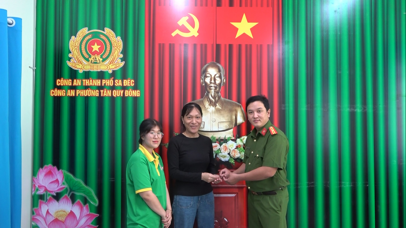 Công an trao trả chiếc bông tai cho chị Yến trước sự chứng kiến của chị Tươi. Ảnh: Thanh Thanh