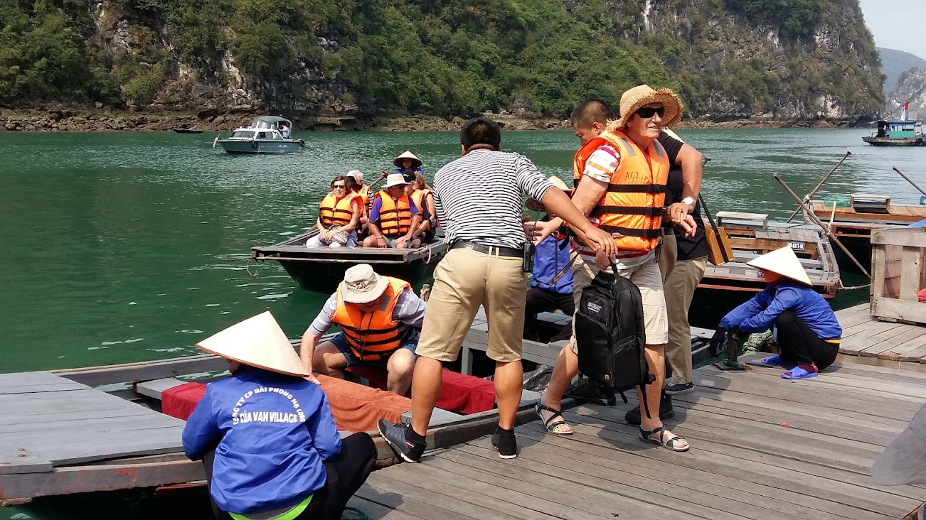 Du khách thích thú với dịch vụ chèo thuyền nan tại Làng chài Cửa Vạn. Ảnh: Nguyễn Hùng
