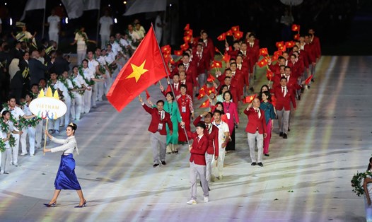 Huy Hoàng cầm cờ cho Đoàn thể thao Việt Nam tại SEA Games 32. Ảnh: Hữu Phạm