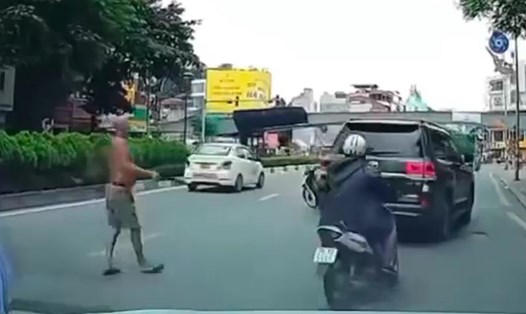 Người đàn ông phi dao vào xe ôtô Land Cruiser giữa phố Hà Nội. Ảnh: Người dân cung cấp