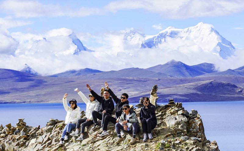 Khách du lịch Trung Quốc chụp ảnh bên hồ Puma Yumco ở Tây Tạng tháng 7.2023. Ảnh: Xinhua