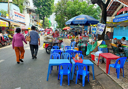 Người dân bày bàn ghế từ vỉa hè xuống lòng đường để buôn bán trên đường Lê Đại Hành (Quận 11). Ảnh: Minh Quân