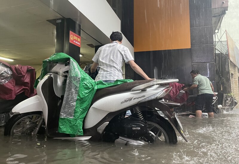 Theo ghi nhận của phóng viên, cơn mưa lớn đầu ngày đã khiến các tuyến đường của Hà Nội ngập sâu. Nhiều phương tiện không thể di chuyển phải dắt bộ. Ghi nhận tại ngõ 204 phố Trần Duy Hưng.
