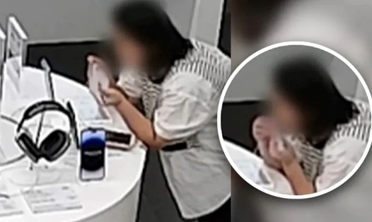 Một người phụ nữ Trung Quốc đã cắn đứt dây cáp chống trộm của Apple tại để trộm chiếc iPhone trưng bày tại cửa hàng. Ảnh: SCMP