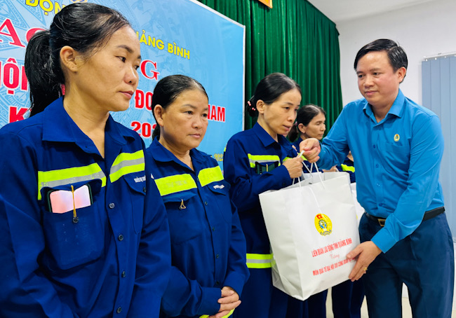 Chủ tịch LĐLĐ Quảng Bình Phạm Tiến Nam trao quà cho người lao động khó khăn. Ảnh: Lê Phi Long