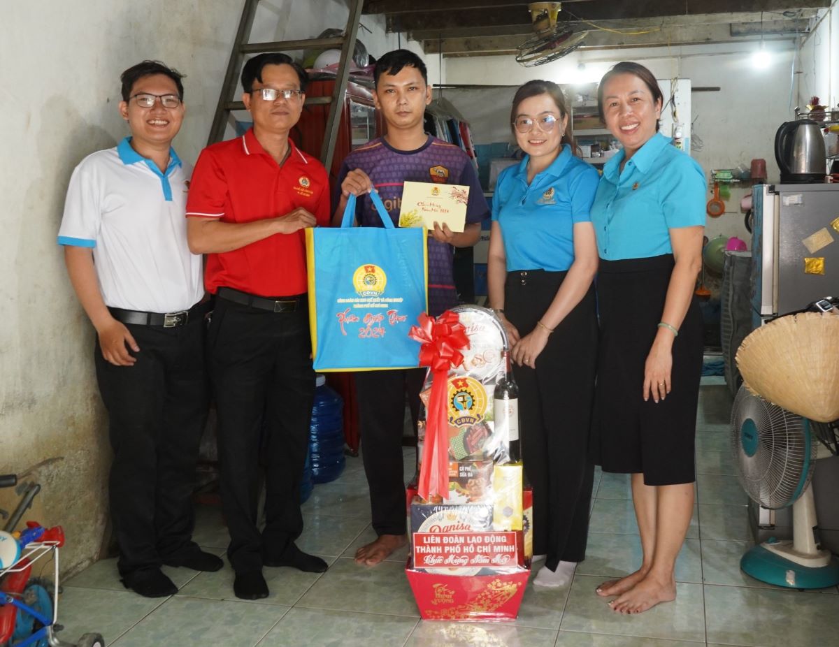 LĐLĐ TPHCM tặng quà Tết cho anh Trần Hoàng Đạo - Công nhân Công ty TNHH Paiho Việt Nam tại nhà trọ. Ảnh: Phương Ngân