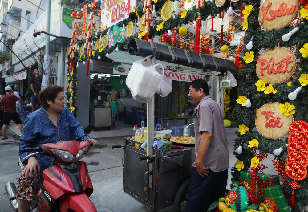 Đường hoa nhỏ trong hẻm không chỉ là công trình thể hiện nét đẹp văn hoá của khu phố mà còn là nơi du ngoạn ngày xuân cho mọi người dân. Nhiều người nô nức dừng chân để check-in.  