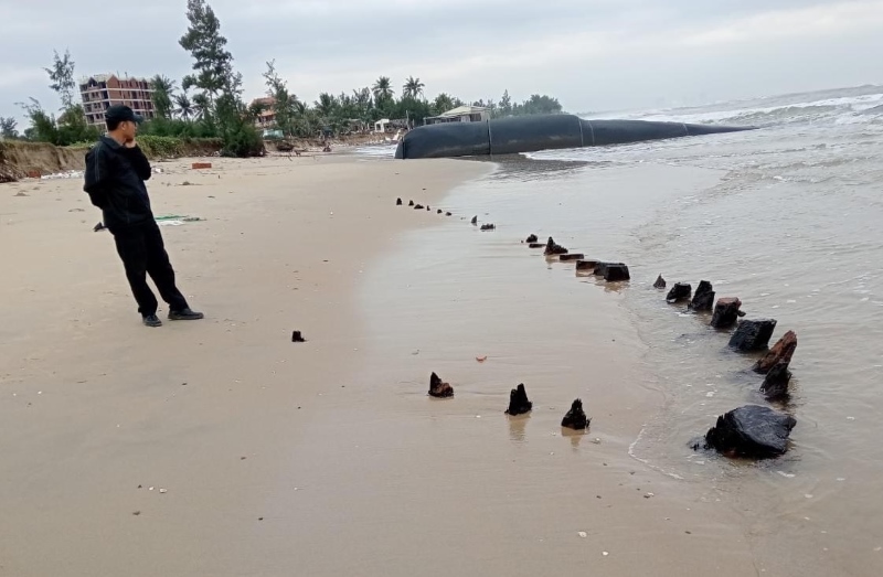 Hiện vật nghi xác tàu cổ được người dân phát hiện nổi lên trên bờ biển Hội An. Ảnh: Hoàng Bin.