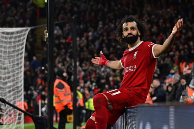 Mohamed Salah “bắt chước” màn ăn mừng của Cristiano Ronaldo sau khi có bàn thắng thứ 150 cho Liverpool tại Premier League. Ảnh: AFP