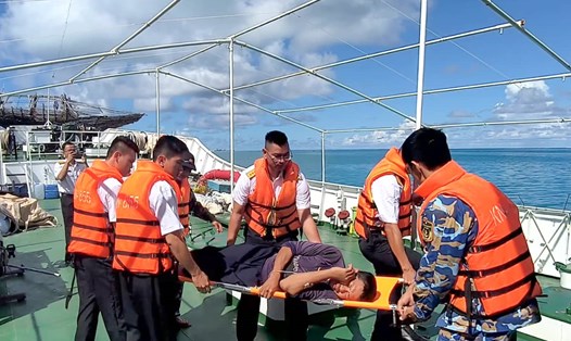 Cán bộ, chiến sĩ Tàu 418 vận chuyển ngư dân từ đảo Tiên Nữ về đảo Sinh Tồn cấp cứu. Ảnh: Trường Sa