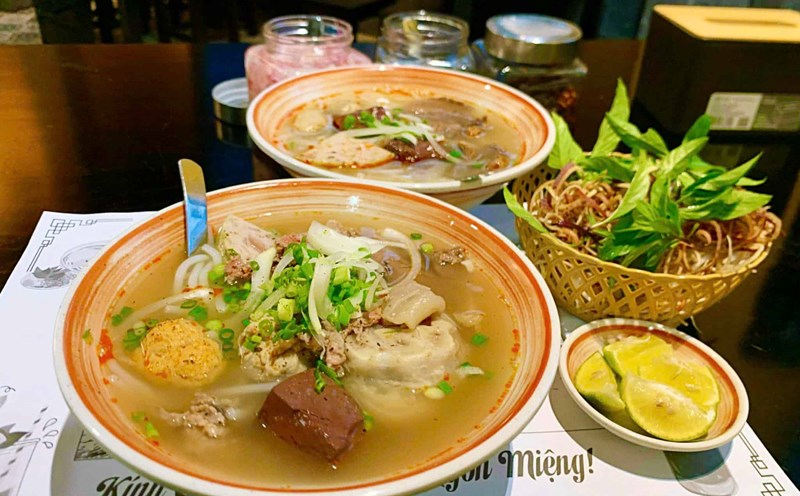 A bowl of Hue beef noodle soup with plenty of fresh ingredients. Photo: Hai Ly