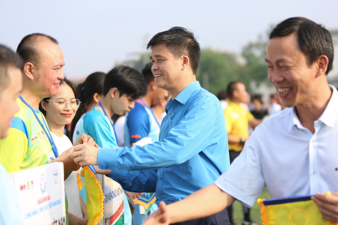 Mr. Ngo Duy Hieu - Vice President of Vietnam General Confederation of Labor (blue shirt) - presented flowers to the football teams. Photo: Hoang Tung
