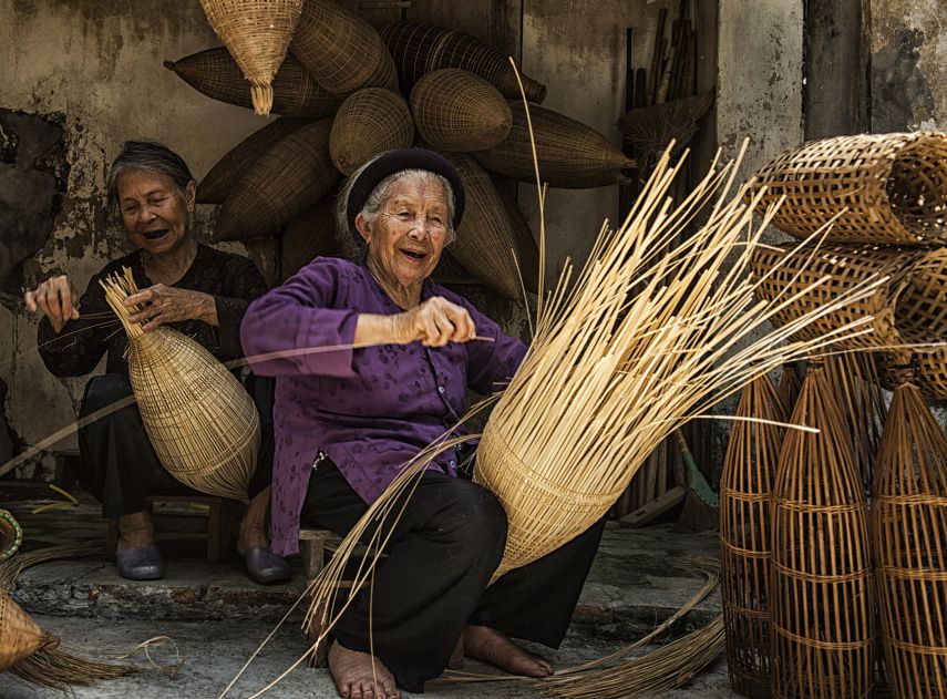 The joy of old age. Two old ladies weaving, in an ancient craft village in Hung Yen.