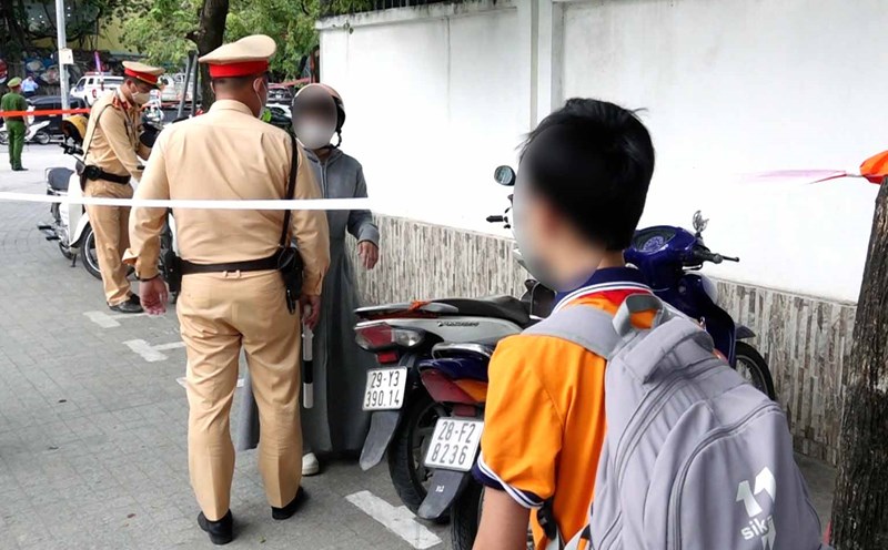 Students wait for parents to sign fine for not wearing helmet