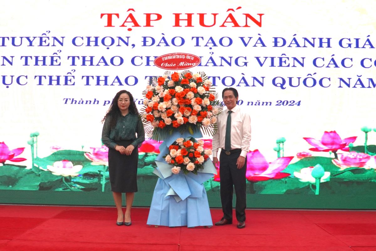 Presenting flowers to the representative of the Ministry of Culture, Sports and Tourism at the opening of the training course. Photo: Thanh An