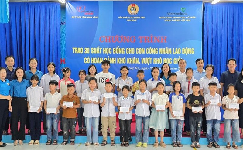 The organizing committee awarded scholarships from the Golden Heart Social Security Fund and took souvenir photos with 30 children of workers of Hung Ha Garment Company Limited who are in difficult circumstances. Photo: Trung Du