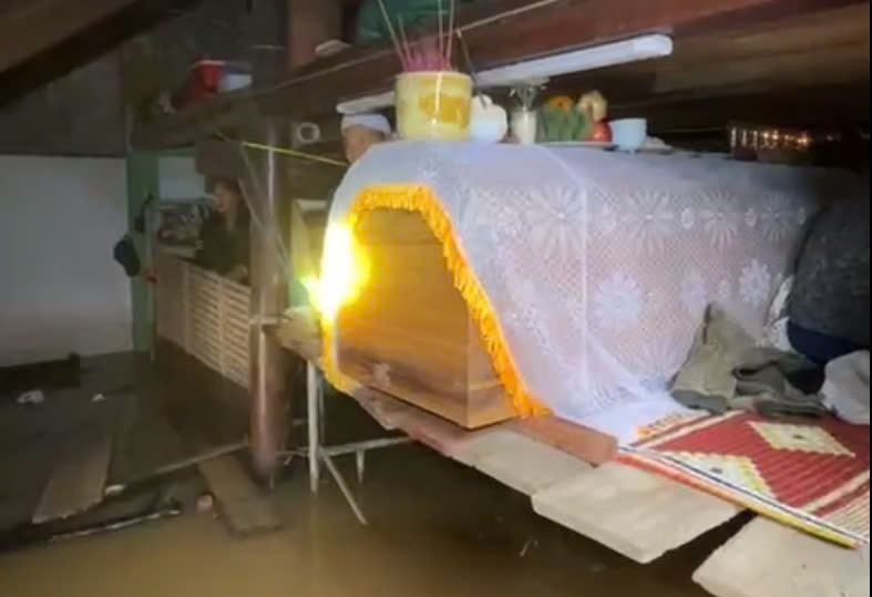 The family had to put Mrs. H's coffin in the attic when the house was flooded. Photo cut from clip