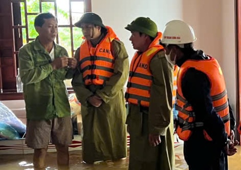 Le Thuy District Police came to encourage the family of someone swept away by the flood. Photo: Le Thuy Police