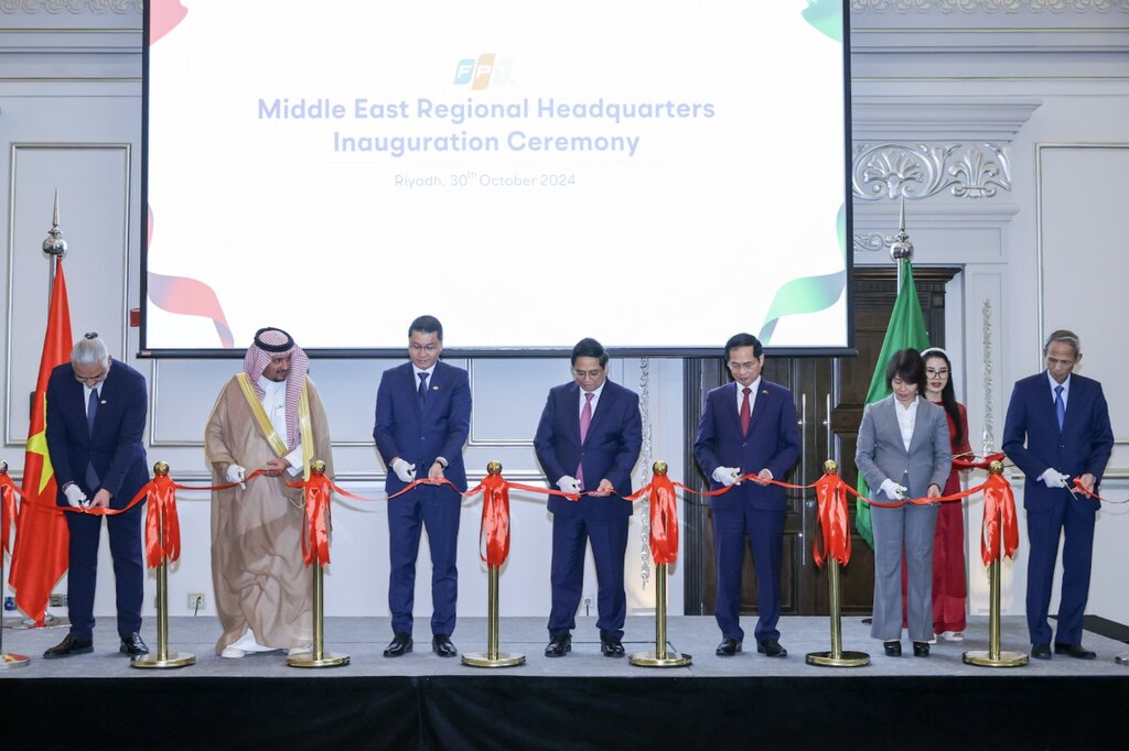 Prime Minister Pham Minh Chinh and delegates perform the ribbon-cutting ceremony at the opening ceremony of FPT office in Saudi Arabia. Photo: AFP