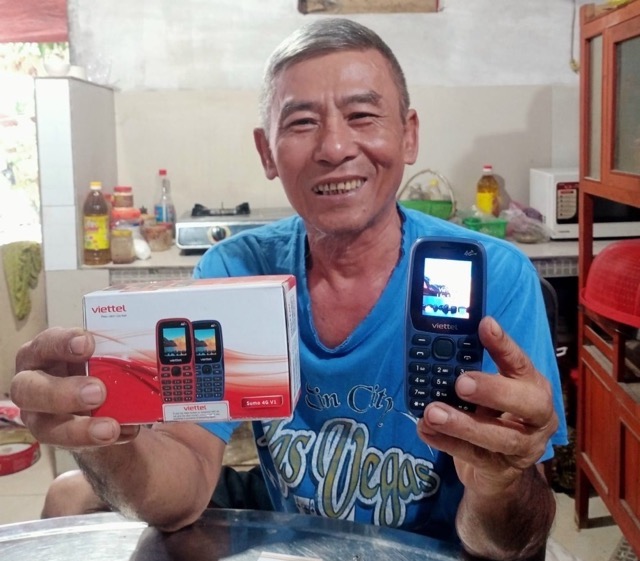 Người dân vui mừng nhận điện thoại mới. Ảnh: ĐVCC