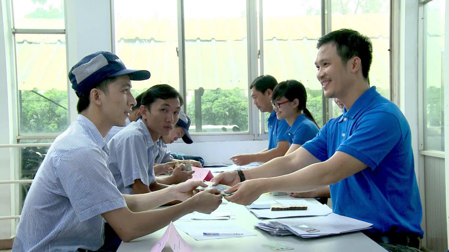 CEP staff handing out loans to workers. Photo: Duc Long
