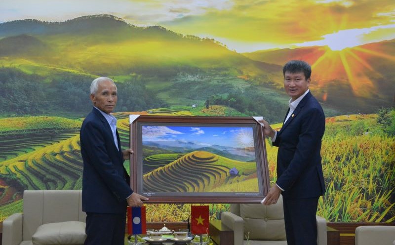 Yen Bai Provincial Party Secretary Tran Huy Tuan presented Lao People's Party Central Committee Secretary Kham Phan Phoi Nha Vong with a picture of Mu Cang Chai terraced fields. Photo: Tran Bui