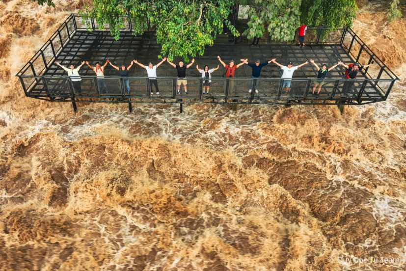 Tourists look at the Li Phi waterfall pouring into the Mekong River. Li Phi waterfall means “ghost trap” in Lao. Photo: Ngo Tran Hai An