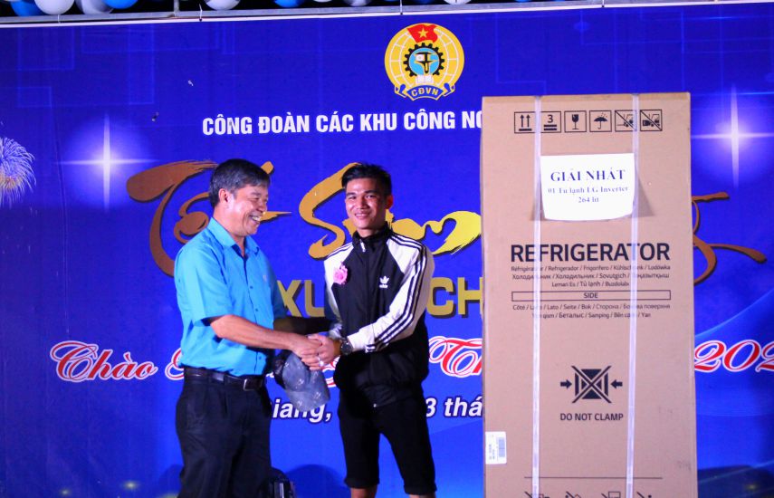 Vice Chairman of An Giang Provincial Federation of Labor Nguyen Huu Giang congratulated union member Tran Thanh Quang on receiving a refrigerator at the Tet Sum Vay event in 2024. Photo: Luc Tung