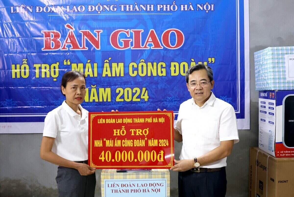 Mr. Nguyen Chinh Huu - Vice President of Hanoi City Labor Federation presented financial support for the construction of the Trade Union Shelter of the City Labor Federation to Ms. Dao Thi Kim Lanh. Photo: Manh Quan