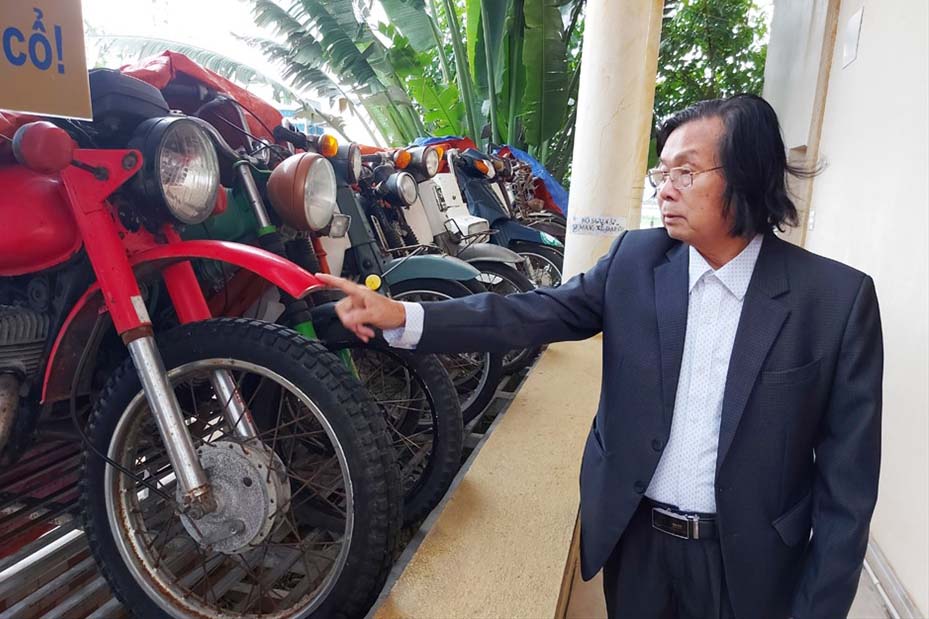 Mr. Nguyen Quang Cuong with his collection of antique motorbikes in his Museum. Photo: Tran Tuan.