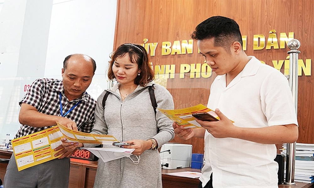 Officials and civil servants of the one-stop shop of Phuc Yen city (Vinh Phuc) guide and handle administrative procedures for people. Photo: Van Nhat