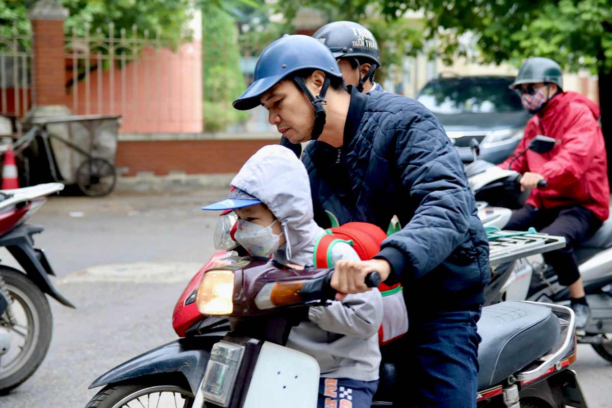 De ngan khong khi lanh, nhieu phu huynh da trang bi day du mu ao, khau trang cho con.