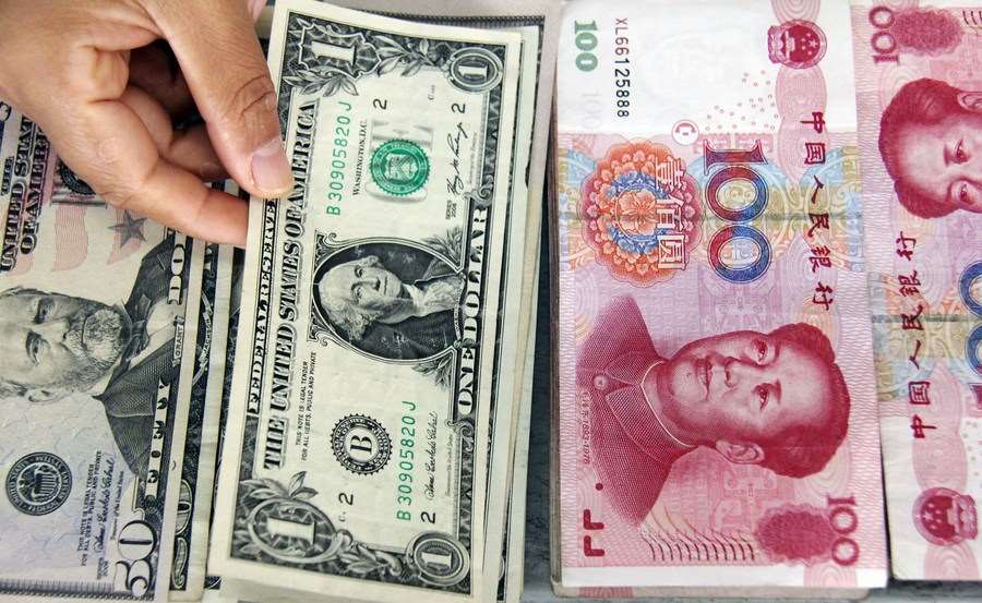 US dollar and Chinese yuan. Photo: Xinhua