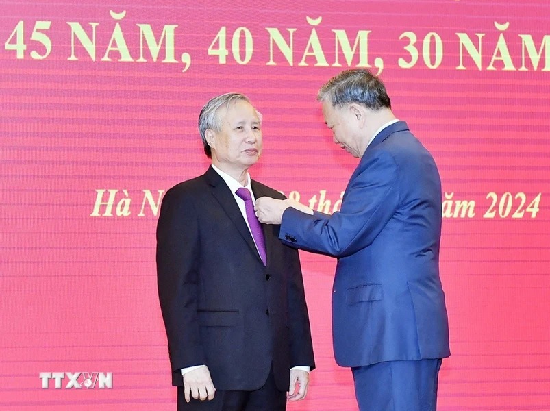 General Secretary To Lam presents the 45-year Party membership badge to Mr. Tran Quoc Vuong, former Politburo member and former Standing member of the Secretariat. Photo: Thong Nhat/VNA