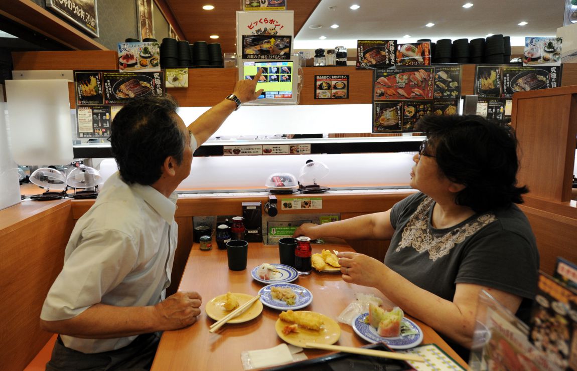 Customers order sushi via a touch screen at a restaurant in Japan. Photo: AFP
