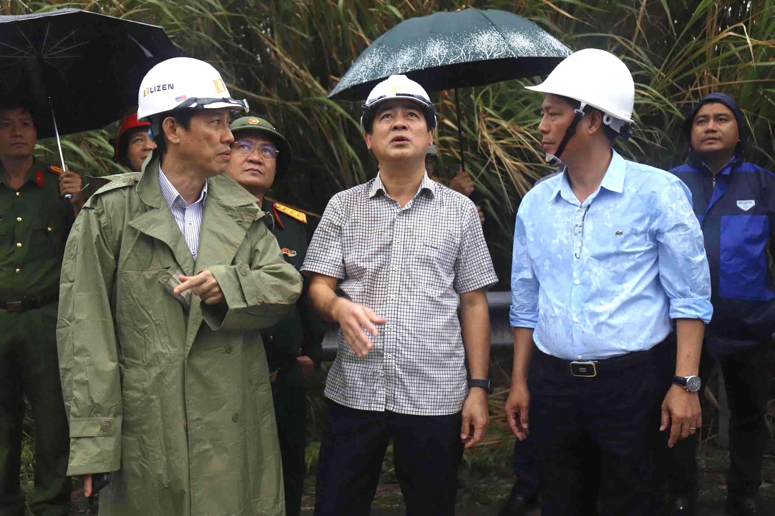 New Khanh Hoa Party Secretary Nghiem Xuan Thanh (plaid shirt, middle) inspects the area where a rock appeared precariously on a cliff. Photo: Huu Long