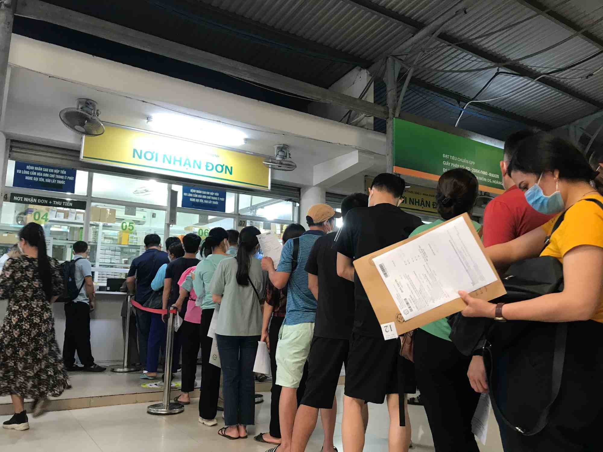 People buy medicine at a medical facility's pharmacy. Photo: Thuy Linh