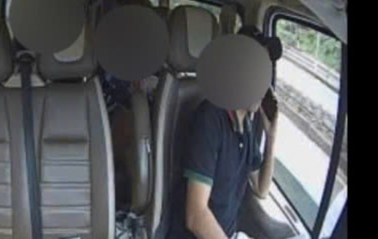 Driver using phone while driving. Photo: Minh Quynh