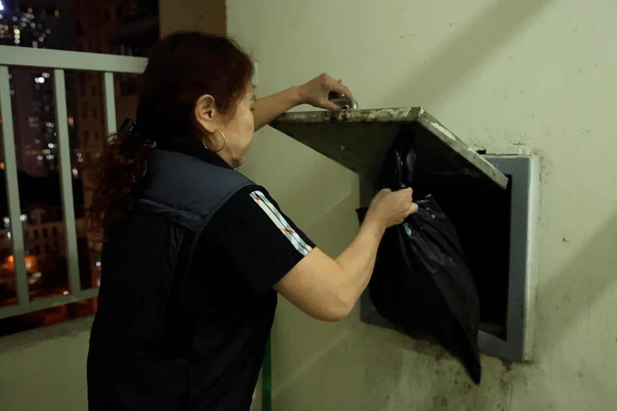 Struggling to sort trash because the apartment building only has one trash chute