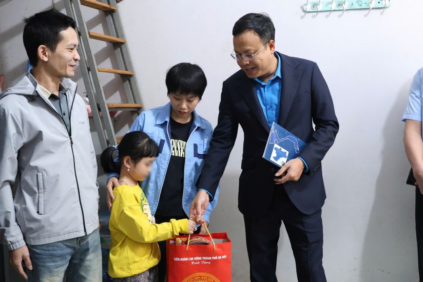 Mr. Pham Quang Thanh - Member of the Presidium of the Vietnam General Confederation of Labor, Chairman of the Hanoi City Confederation of Labor (right) presents Tet gifts to Ms. Tran Thi Hien's family. Photo: Mai Quy