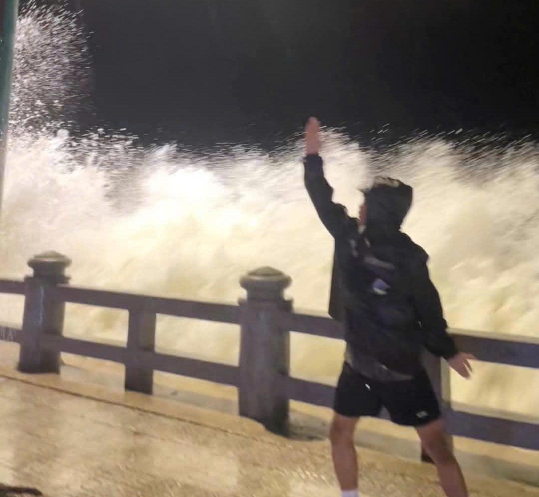 The waves are big but people still go to Nha Trang beach to take pictures. Photo: Huu Long