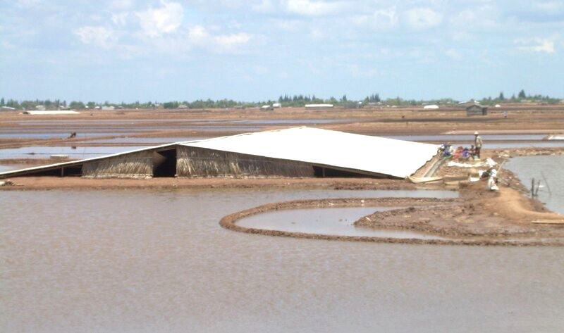 Salt farmers in Bac Lieu prepare for the new salt season but encounter unseasonal rain and have to wait for the sun to shine. Photo: Nhat Ho