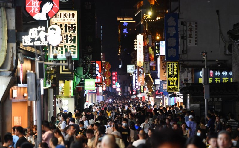 A bustling old town at night in the capital city of Hunan Province, China. The city government has launched many activities to promote consumption, helping the local night-time economy to boom and develop strongly. Photo: Xinhua