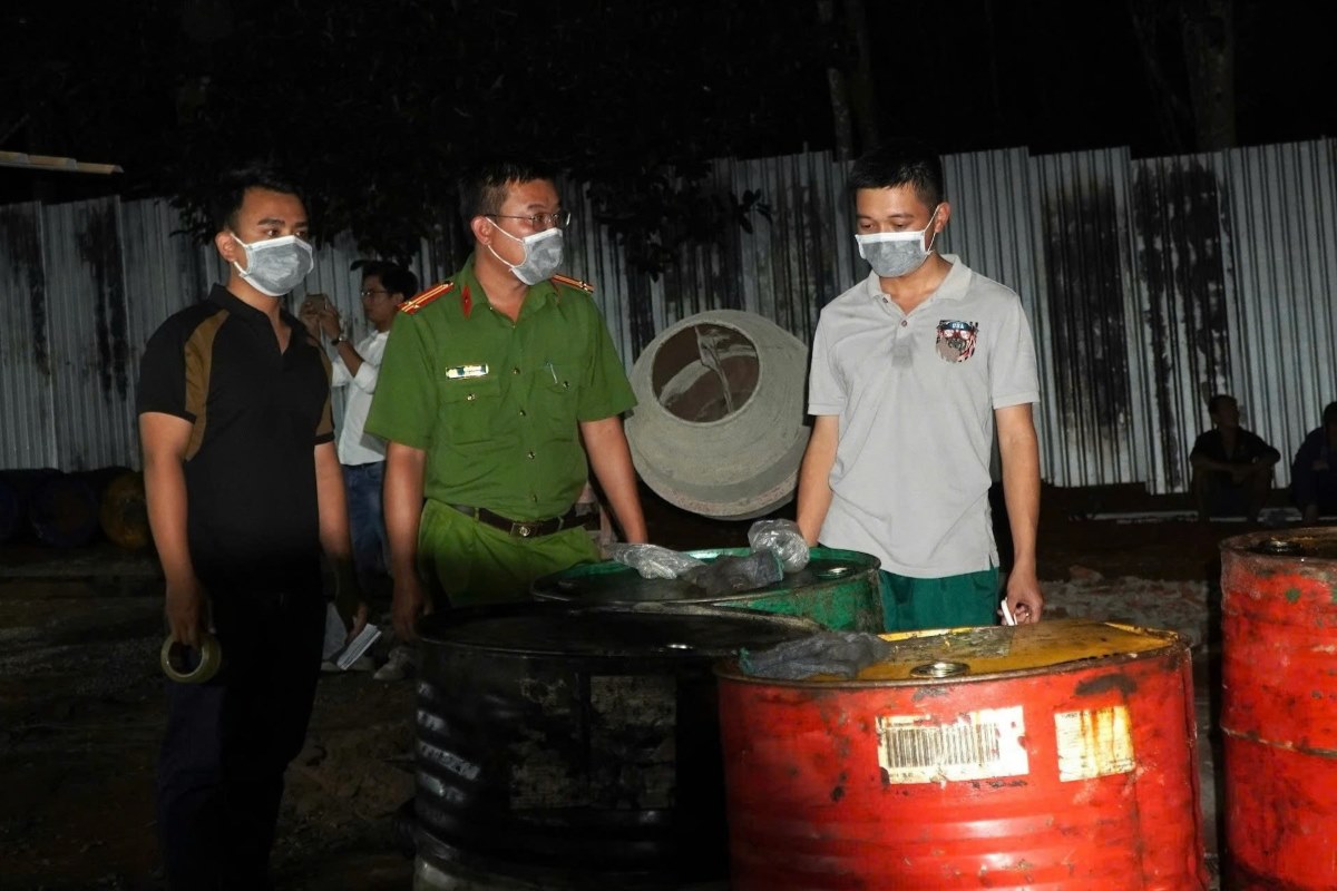 Authorities inspect a waste oil recycling facility deep in a rubber forest. Photo: Thai Binh