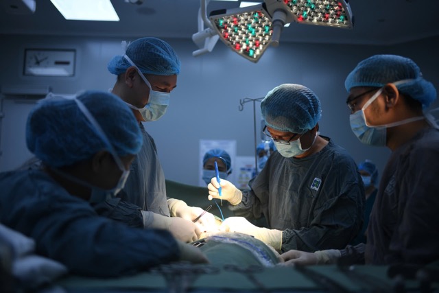 Doctors are performing a tumor removal and breast reconstruction surgery for a breast cancer patient. Photo: THUY DIEM