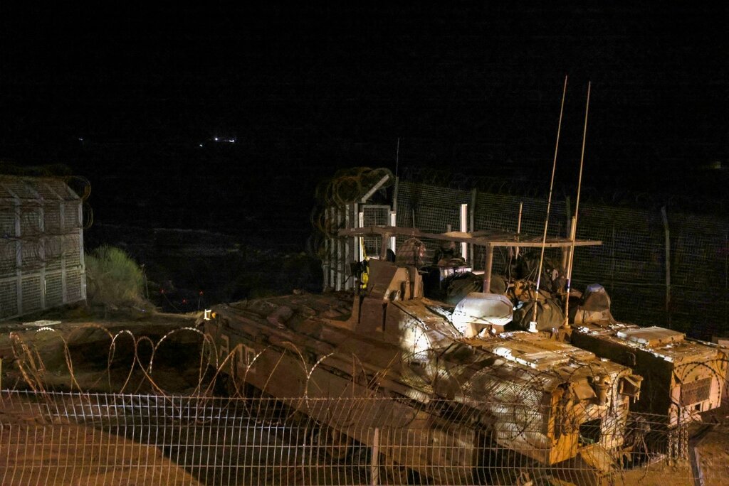 Israeli armored vehicles cross the fence into Syria near the village of Majdal Shams in the Golan Heights on December 8. Photo: AFP