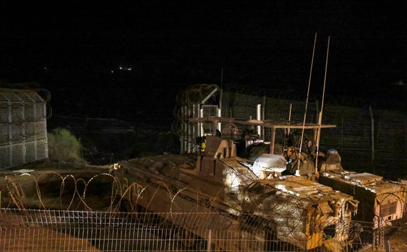 Israeli armored vehicles cross the fence into Syria near the village of Majdal Shams in the Golan Heights on December 8. Photo: AFP