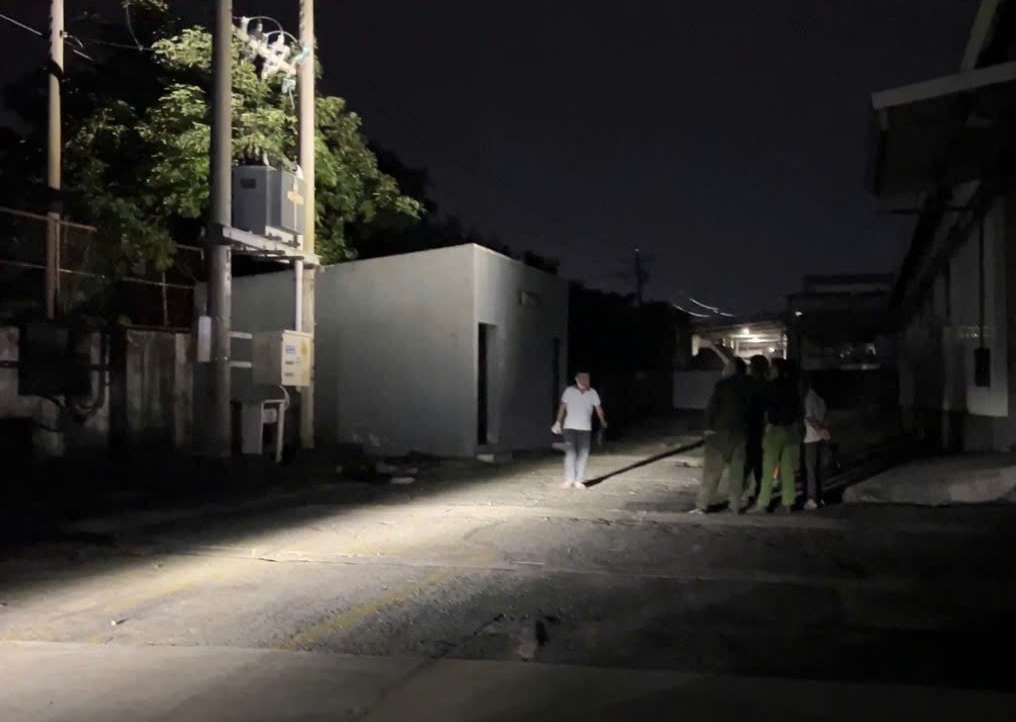 Police inspect the scene where a man was electrocuted to death after stealing a cable. Photo: Duong Binh